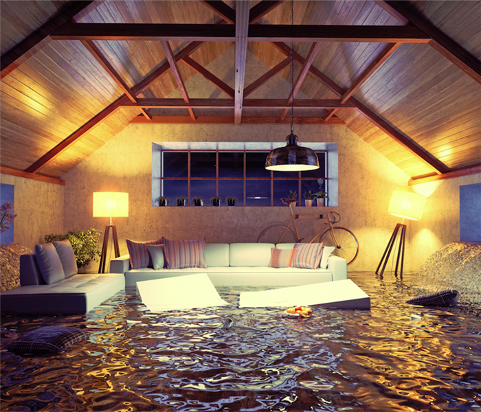 a flooded living room with water coming through the windows